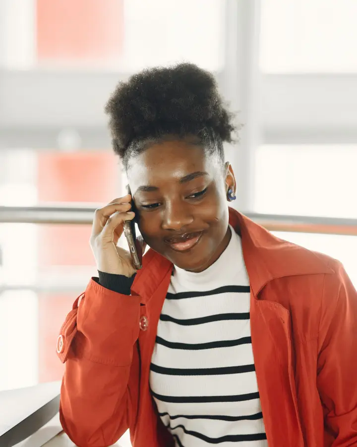 A client smiling while she talks on the phone.